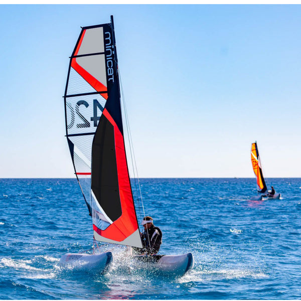 Minicat 420 Evoque Red sailing agressively on the water