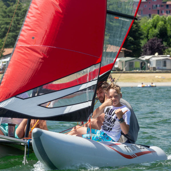 young boy giving a thumbs up on a Red MiniCat 420 Evoque