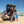 Load image into Gallery viewer, MiniCat Guppy being loaded into the trunk of a car