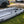 Load image into Gallery viewer, 2021 Takacat T380LX demo inflatable catamaran boat side view with oars attached
