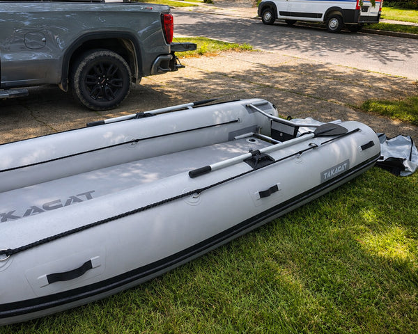 2021 Takacat T380LX demo inflatable catamaran boat side view with oars attached